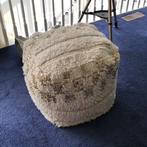 White pouf ottoman with gold accents